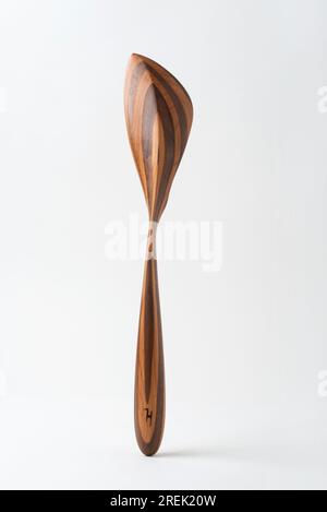 Handmade wooden kitchen utensil, from two wood species. Stock Photo