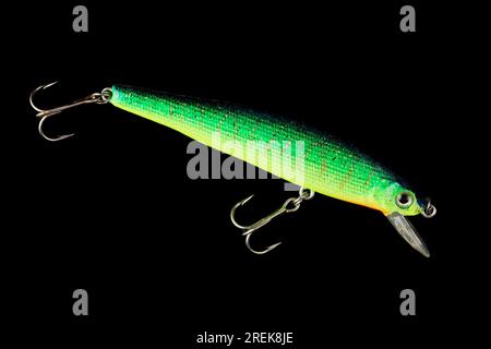 Bright green minnow plastic fishing lure isolated on black background Stock  Photo - Alamy