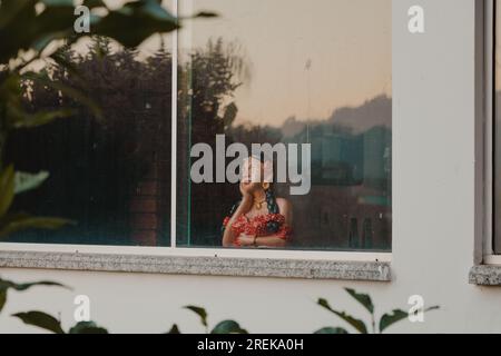 girl looking at the window Stock Photo