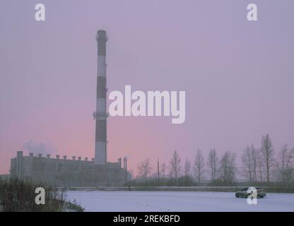 Machine and boiler room against a pinkish sky. The photo was taken during a strong blizzard Stock Photo