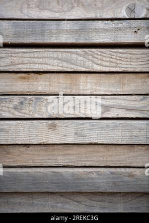 row of wooden planks forming a fence with different grains and patterns. Stock Photo