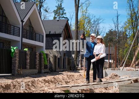 Man house developer asking questions to woman head architect about construction Stock Photo