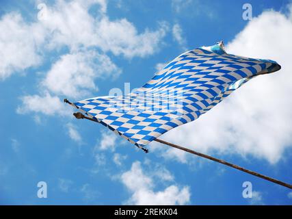 Bavarian flag in the wind on blue and white sky Stock Photo