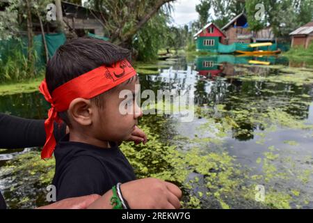 Srinagar, India. 28th July, 2023. A young Shiite Muslim mourner looks on as he attends a Muharram procession in Srinagar. Muharram is a month of mourning in remembrance of the martyrdom of Imam Hussain, the grandson of Prophet Muhammad (PBUH). Credit: SOPA Images Limited/Alamy Live News Stock Photo