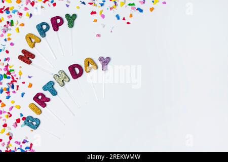 Flat lay happy birthday lettering white background with copy space. Beautiful photo Stock Photo