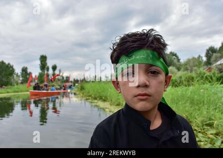 Srinagar, India. 28th July, 2023. A young Shiite Muslim mourner poses for a picture during a Muharram procession in Srinagar. Muharram is a month of mourning in remembrance of the martyrdom of Imam Hussain, the grandson of Prophet Muhammad (PBUH). (Photo by Saqib Majeed/SOPA Images/Sipa USA) Credit: Sipa USA/Alamy Live News Stock Photo