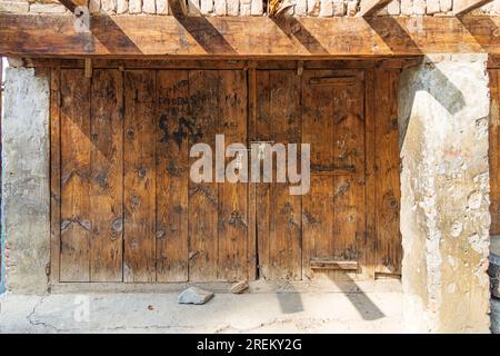 Berna Bugh, Kangan, Jammu and Kashmir, India. October 27, 2022. Padlocks on a weathered wooden door. Stock Photo