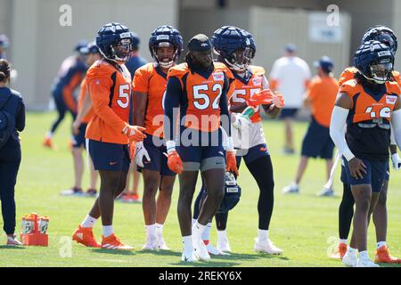 Denver Broncos linebacker Randy Gregory, back, looks on as Denver Broncos  linebacker Marcus Haynes, front left, takes part in a drills with  linebacker Thomas Incoom during an NFL football training camp at