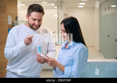 Dentist and pretty female are chatting in the hospital corridor Stock Photo