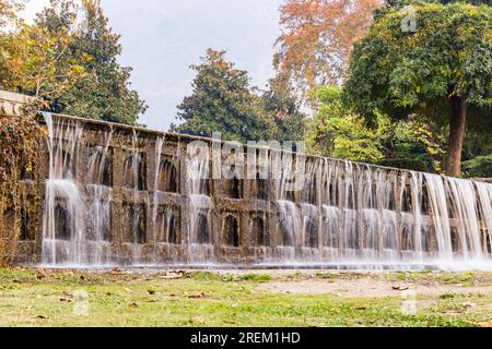 Srinagar, Jammu and Kashmir, India. October 30, 2022. Artificial waterfall in Mughal Garden. Stock Photo