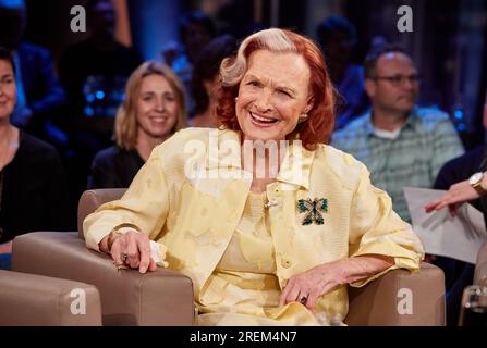 Hamburg, Germany. 05th July, 2023. Grandma look: a young woman wears a  flower dress with a white jacket and sneakers while she is out on the town.  Crocheted jackets, long dresses decorated