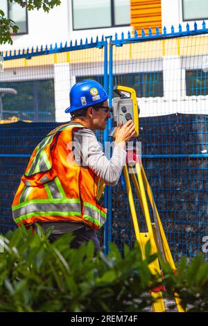Survey technician using a laser theodolite on a construction site in Vancouver Canada Stock Photo