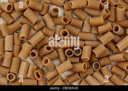 Tubes of cut whole wheat pasta placed in bulk Stock Photo