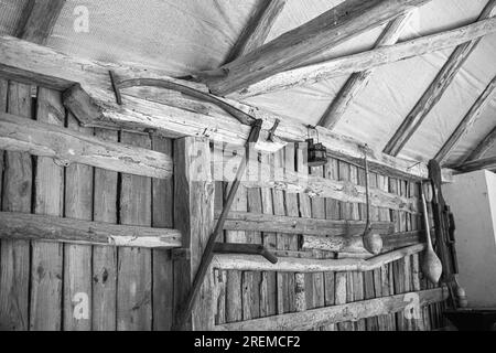 Antique scythe hanging on the wall in the barn.Old farm tools. High quality photo Stock Photo