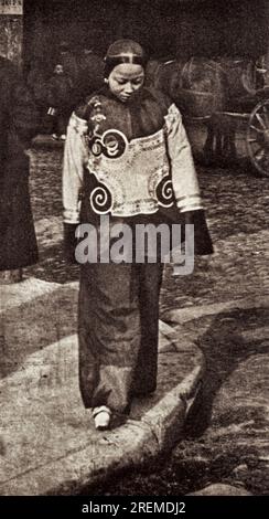 San Francisco, California:   c. 1890 A slave girl in Chinatown wearing holiday attire. From a photograph by Arnold Genthe. Stock Photo