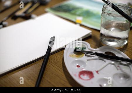 watercolor, painting, wooden background, brushes and water. Stock Photo
