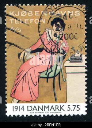 DENMARK - CIRCA 2000: stamp printed by Denmark, shows Advertising sticker showing woman on telephone, circa 2000 Stock Photo