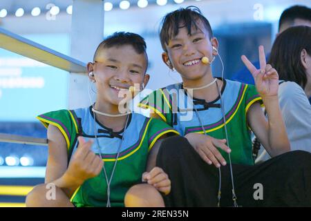 (230729) -- CHENGDU, July 29, 2023 (Xinhua) -- Jiziyisheng (L) and Jiduoshila pose prior to a rehearsal of the opening ceremony in Chengdu of southwest China's Sichuan Province, July 16, 2023. Six children dressed in traditional Yi ethnic costumes choired a song to inaugurate the opening ceremony of the 31st summer edition of the FISU World University Games. Jihaoyouguo, Jihelazuo, Ma Jieying, Edirehan, Jiziyisheng and Jiduoshila came from Zhaojue County, Liangshan Yi Autonomous Prefecture, southwest China's Sichuan Province. Despite their age differences, they all share a common hobby of sing Stock Photo