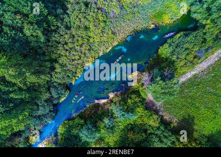 Canoeing tourists on the clear waters of the Tirino river Stock Photo