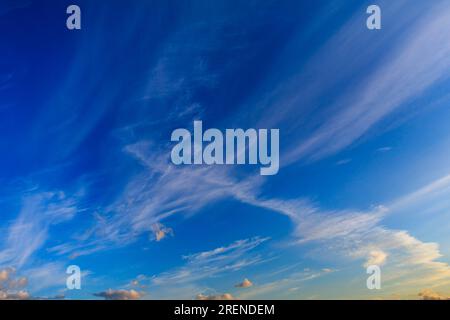 High altitude cirrus clouds against a deep blue sky Stock Photo