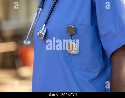 African nurse with a stethoscope and a specialized FOB watch, to keep time at the hospital Stock Photo