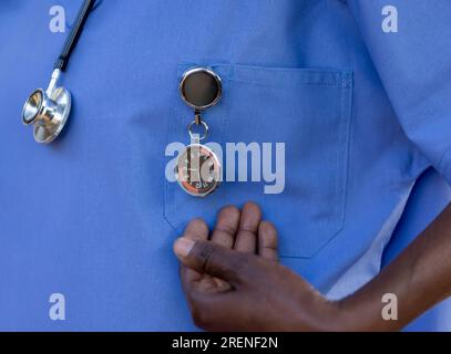 African nurse with a stethoscope and a specialized FOB watch, to keep time at the hospital Stock Photo