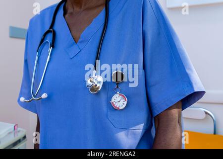 African nurse with a stethoscope and a specialized FOB watch, to keep time at the hospital Stock Photo