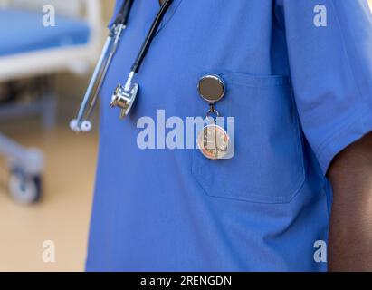 African nurse with a stethoscope and a specialized FOB watch, to keep time at the hospital Stock Photo