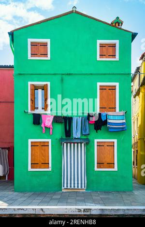 Tranquil scene with the colorful houses in Burano island, Venice. Clothes laundry left to dry Stock Photo