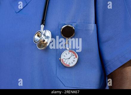 African nurse with a stethoscope and a specialized FOB watch, to keep time at the hospital Stock Photo