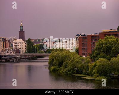 View of buildings by river against sky Stock Photo