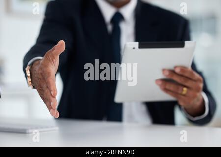 Handshake, meeting and a businessman with a tablet at work for an interview or company onboarding. Thank you, hr and a manager or employee extending a Stock Photo