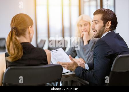 business manager businesspeople talking together conversation at office meeting room happy talk discussion with team Stock Photo