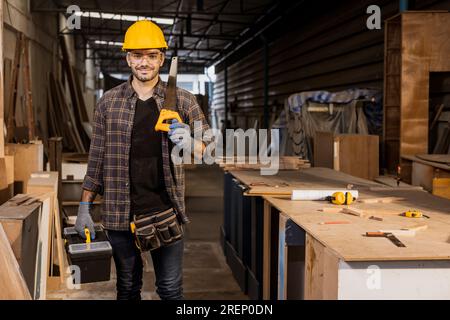 portrait hispanic indian male wood worker standing with tools happy smile, construction builder man. Stock Photo