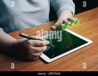 Woman use digital tablet marking check boxes. Successful completion of business tasks. Digital marketing strategy. Business goals. Stock Photo