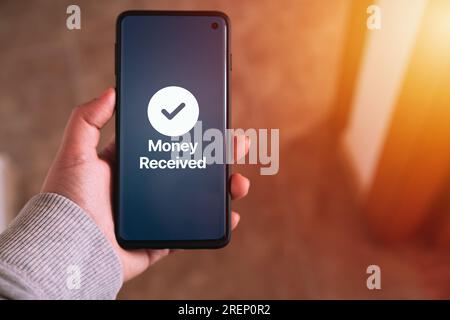 Woman transfering money online using apps on smartphone. Selective focus. Concept of financial transactions with mobile devices. Stock Photo