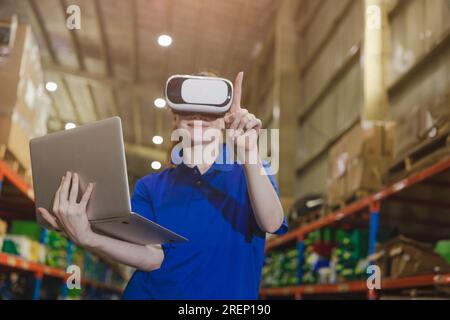 smart worker using modern advance technology digital VR device to control operate manage industry products stock warehouse Stock Photo