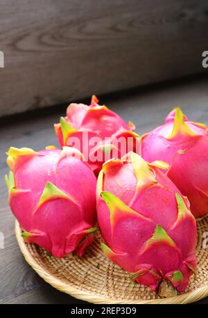 Heap of Fresh Ripe Dragon Fruits in a Basket Stock Photo