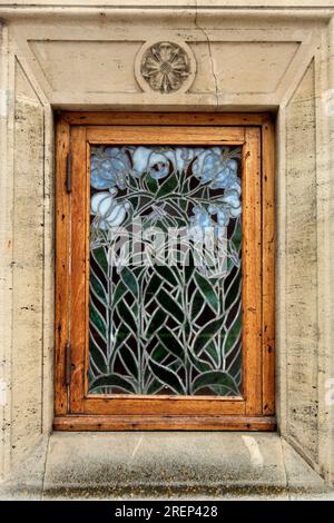 Small stained glass window with a floral design in the Art Nouveau 19th century Aarhus Theatre, Aarhus, Denmark. Stock Photo