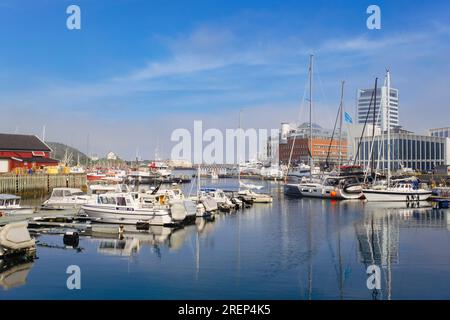 Boats moored in the harbour with modern buildings in the town. Bodo, Nordland, Norway, Scandinavia, Europe Stock Photo