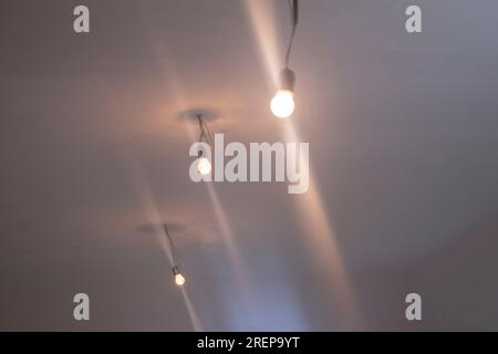 White concrete ceiling with bright bulbs Stock Photo