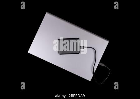 laptop and hard drive isolated on black background top view Stock Photo
