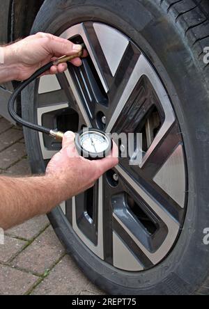 Check the tire pressures with a pressure gauge Stock Photo