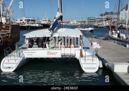 Sailing Catamaran Tigresse in Cape Town full of passenger ready for sunset cruise along beautiful coastline. Stock Photo