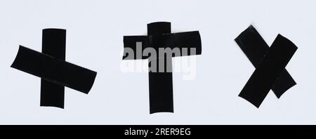 Set of crossed rubber sticky black tape isolated on white studio background Stock Photo