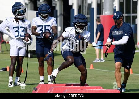 Tennessee Titans running back Tyjae Spears, right, runs the ball as  Jonathan Ward (33) defends during an NFL football training camp practice  Saturday, July 29, 2023, in Nashville, Tenn. (AP Photo/Mark Zaleski