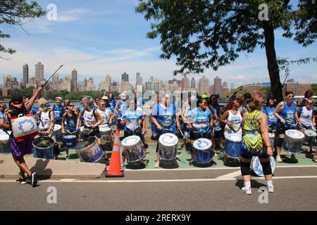 New York, USA. 29th July, 2023. A music group plays on a temporarily car-free street in the New York borough of Queens. On bicycles, roller skates or on foot, thousands of people paraded along miles of car-free streets in New York on Saturday. The popular 'Summer Streets' program had been expanded this year for the first time to all five boroughs of the metropolis of millions. Credit: Christina Horsten/dpa/Alamy Live News Stock Photo