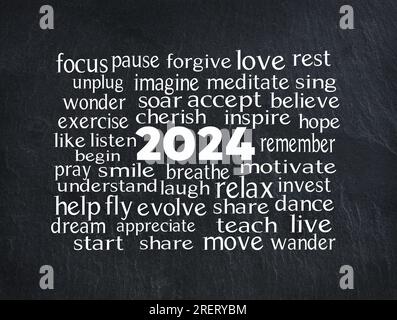 New Year 2024 word cloud with white text on a black slate background Stock Photo