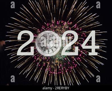 New Year 2024 moon clock with fireworks on black sky Stock Photo