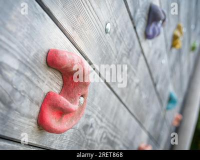 Red climbing grip on a board for exercising Stock Photo